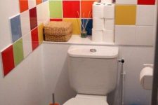 a small and bright powder room refreshed with bright multi-color tiles, with white appliances is a super cool and fresh idea to rock