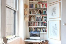 a small working nook with built-in bookshelves, a small desk and a vintage chair is a stylish eclectic space