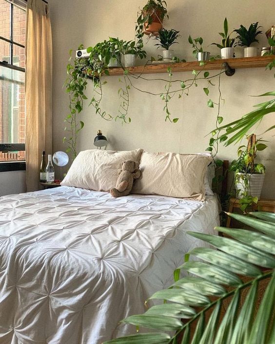 a welcoming boho spring bedroom in neutrals, with potted greenery and some accessorie sis welcoming