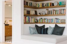 a welcoming nook with built-in shelves and a comfy daybed is a cool space to spend some time reading and relaxing