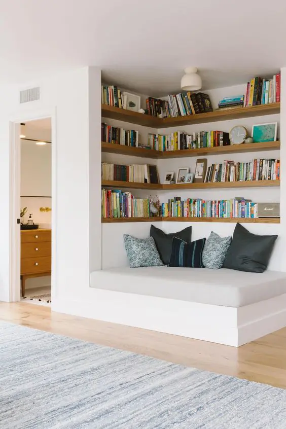 A welcoming nook with built in shelves and a comfy daybed is a cool space to spend some time reading and relaxing