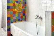 a white bathroom accented with super bold and bright tiles around the bathtub to highlight this space and make it outstanding