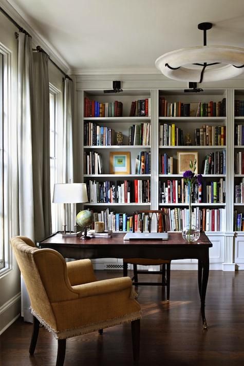 An elegant home office with built in bookshelves, a refined desk and chair is a cool place to be