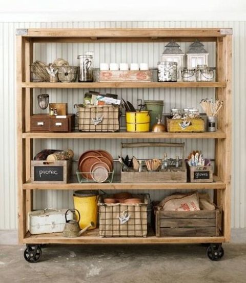 an oversized wooden shelving unit with metal wheels is a great idea to store and see everything you place there at the same time