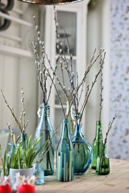 blue and green bottles and vases with willow make a natural and cool spring decoration or Easter centerpiece