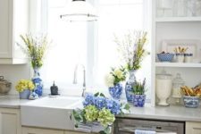 bright blue porcelain, blue and green hydrangeas, blooming branches for a spring farmhouse kitchen