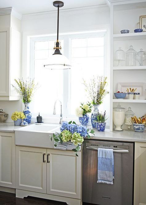 bright blue porcelain, blue and green hydrangeas, blooming branches for a spring farmhouse kitchen
