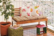 cheerful printed pillows and a pink footrest will immediately bring a fresh spring feel to the balcony