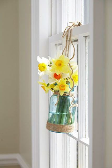 decorate your window with a jar with daffodils and twine to give it a rustic and relaxed feel with a spring touch