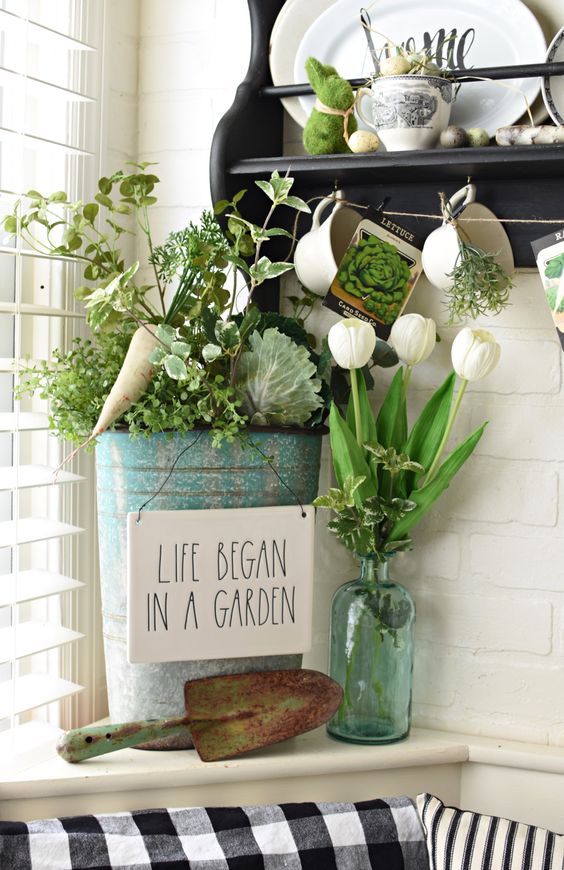 greenery in a bottle, a bucket with greenery and veggies and a moss bunny for a spring or Easter look