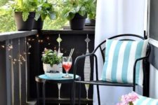 light blue printed pillows and a rug and potted pink flowers turn this balcony in a light inviting space