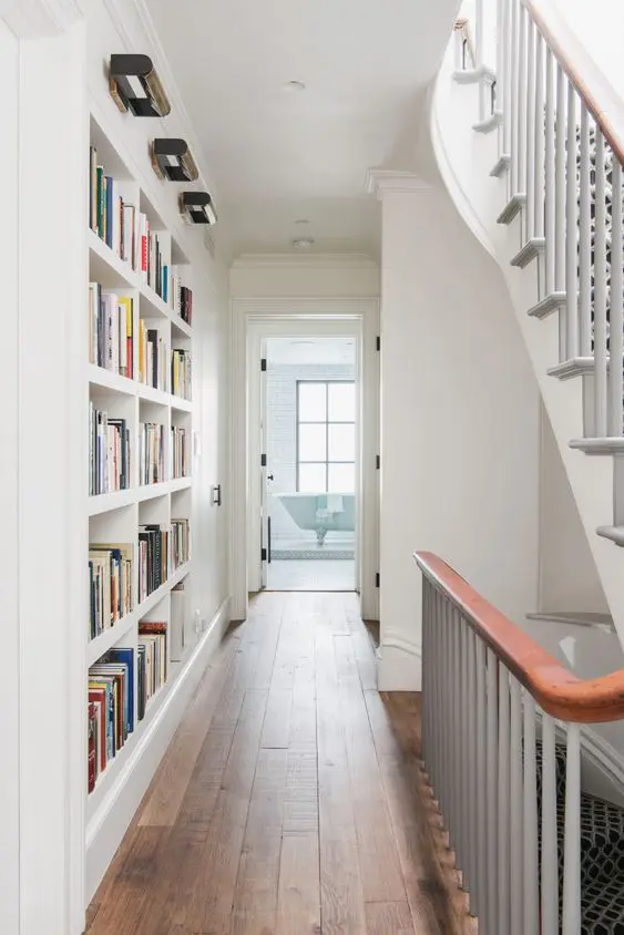 make osme built-in bookshelves in your passway or corridor to use this wall and save a lot of space