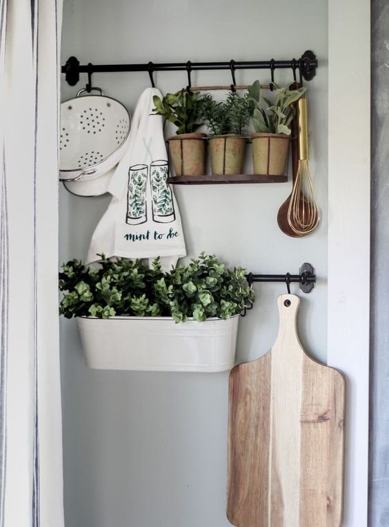 planters and pots with fresh greenery and printed towels make the kitchen fresh and spring-like and do that with style