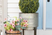potted fake blooms and greenery and a boxwood topiary will make your porch look fresh and spring