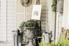 potted greenery and a greenery wreath plus some vintage stuff and lanterns for an elegant spring porch