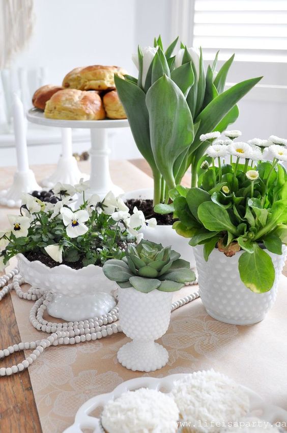 potted greenery, blooms and succulents in white porcelain will make your tablescape look bold, fresh and spring-like