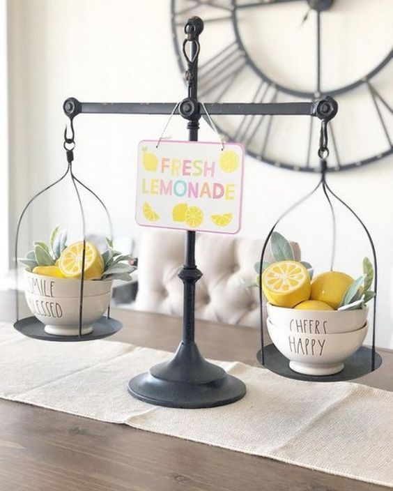 scales with faux lemons and greenery in bowls and a colorful sign will remind you of spring and summer