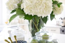 white hydrangeas in a clear vase and limes in a clear jar will make your kitchen feel like spring