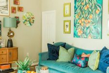 a colorful living room with a turquoise sofa and a catchy geometric coffee table, bold artwork and a beaded chandelier