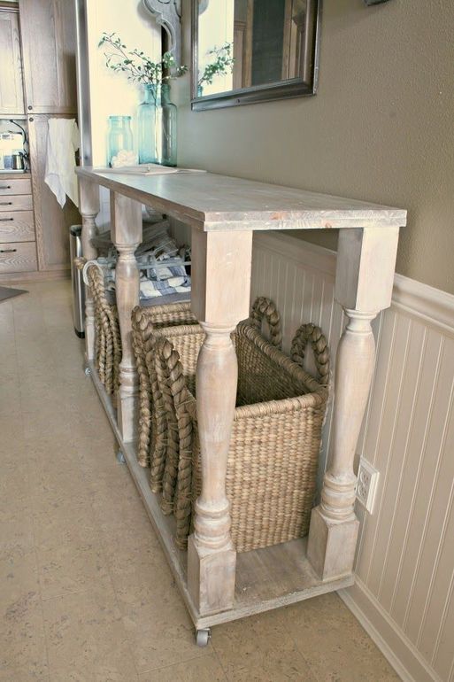 a long and large white console table on casters with baskets for storage is a nice idea for a farmhouse or just vintage space