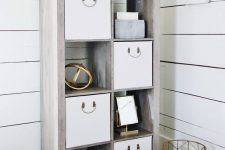 a modern whitewashed shelving unit with storage baskets and boxes is a cool idea for a modern farmhouse space