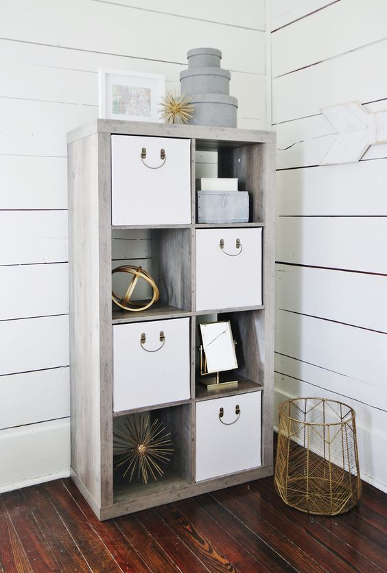 a modern whitewashed shelving unit with storage baskets and boxes is a cool idea for a modern farmhouse space
