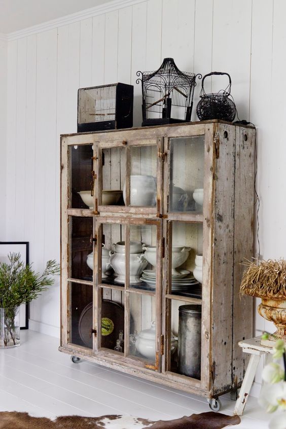 a whitewashed and brushed shabby chic storage unit with sliding glass doors is a very pretty and cool idea