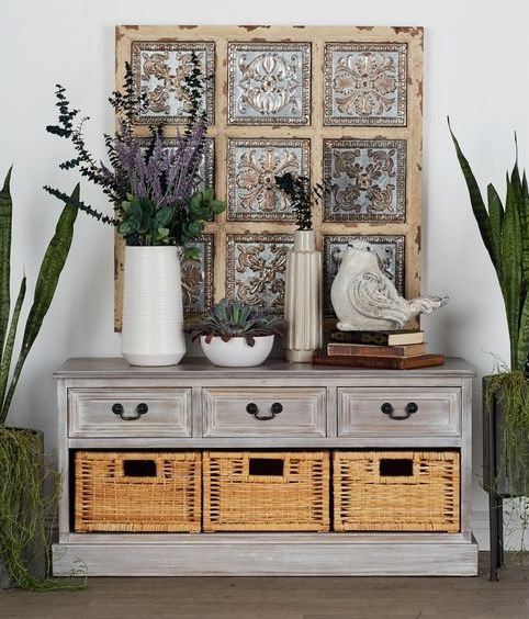 a whitewashed storage unit with lots of drawers and baskets for storage is a stylish idea for a shabby chic or rustic space
