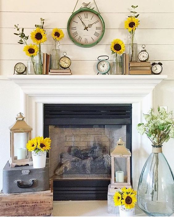 a cheerful summer mantel with sunflowers, vintage clocks, vintage books and candle lanterns around