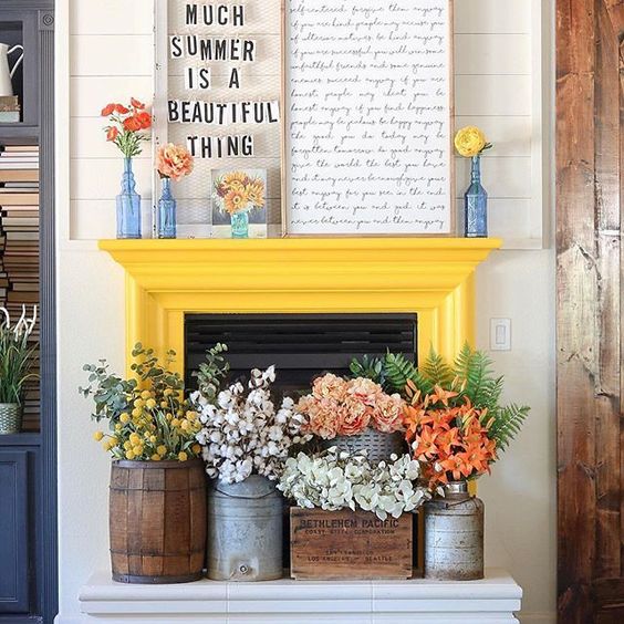 a couple of signs, bright blooms in vases and lush floral arrangements in crates and churns for summer decor