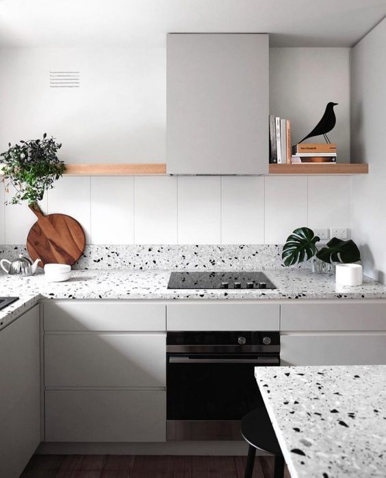 a minimalist grey kitchen with grey terrazzo countertops that add an eye-catchy touch