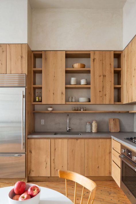 a minimalist kitchen with sleek wooden cabinets and a concrete countertop and backsplash is super stylish