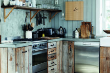 a powder blue chalet kitchen with a plank and plaster wall, reclaimed wooden cabinets and concrete countertops