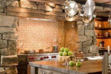 a vintage chalet kitchen with a tile backsplash, stone walls, a wooden ceiling and a large stained kitchen island