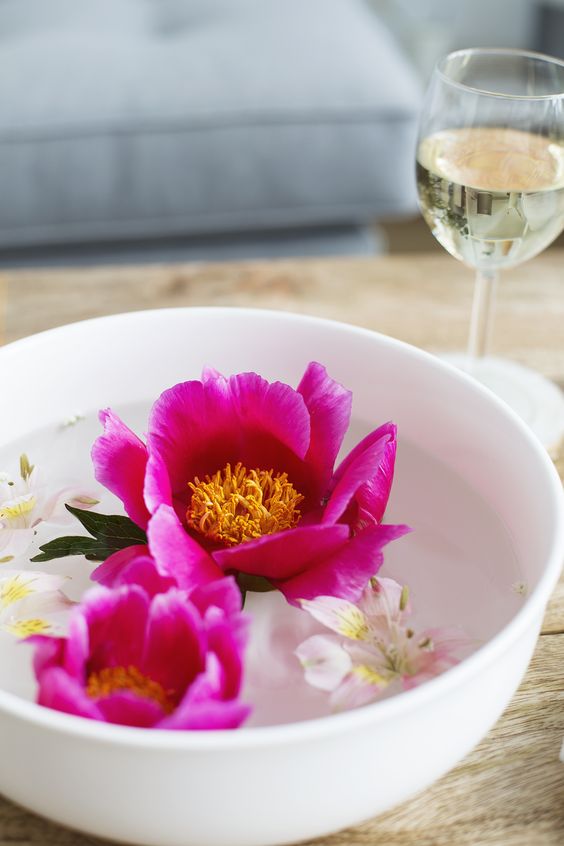 a bowl with floating bright blooms is a beautiful and simple summer centerpiece or decoration