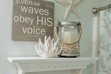 a coastal bathroom with starfish, corals and a candle lantern and with a shelf with starfish feels very cool and very stylish