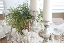 a coastal centerpiece of corals, grasses, candles in lovely candleholders is a very chic and cool idea to rock