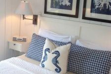 a nautical bedroom with coral artworks, nautical bedding and simple white furniture is a very fresh and cool idea to rock