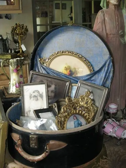 a vintage round suitcase filled with vintage photos is a beautiful and refined decoration for an elegant home