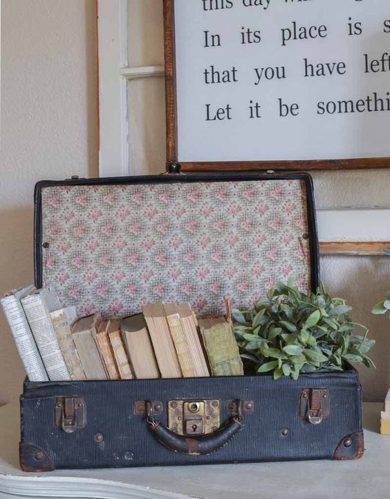 a vintage suitcase filled with books and a potted plant is a great alternative to a usual crate or box and you needn't overdo it