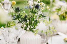 a white patterned vase with wildflowers is a lovely and relaxed summer centerpiece or decoration