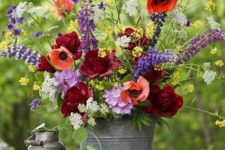 place your colorful floral arrangement into a simple metal bucket to make your summer decor bright and fun