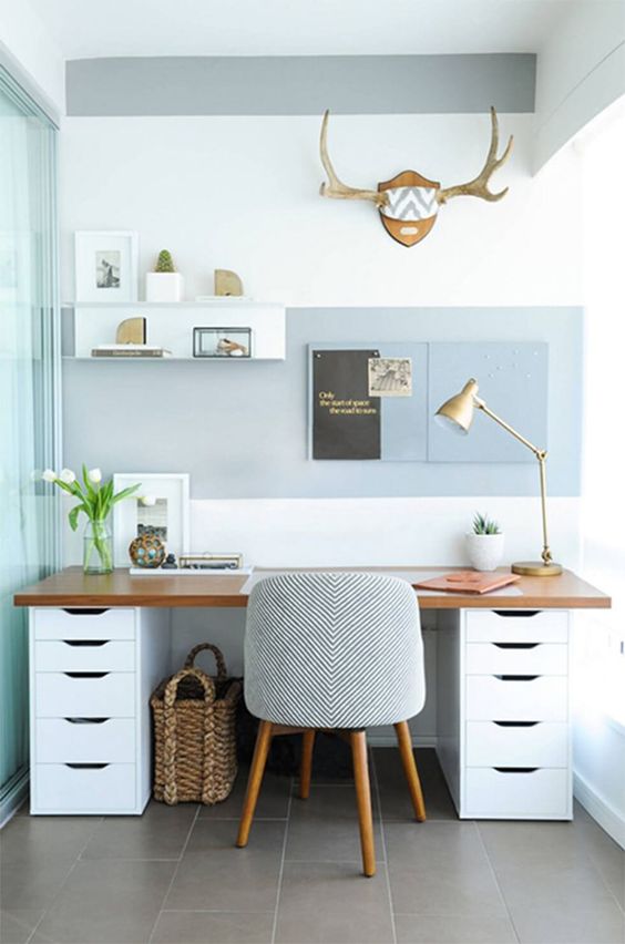a breezy beach home office in grey and white, with a cool and comfy desk, a striped chair, a shelf on the wall
