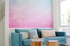 a bright turquoise to pink gradient wall is a gorgeous statement in the space, it brings much color