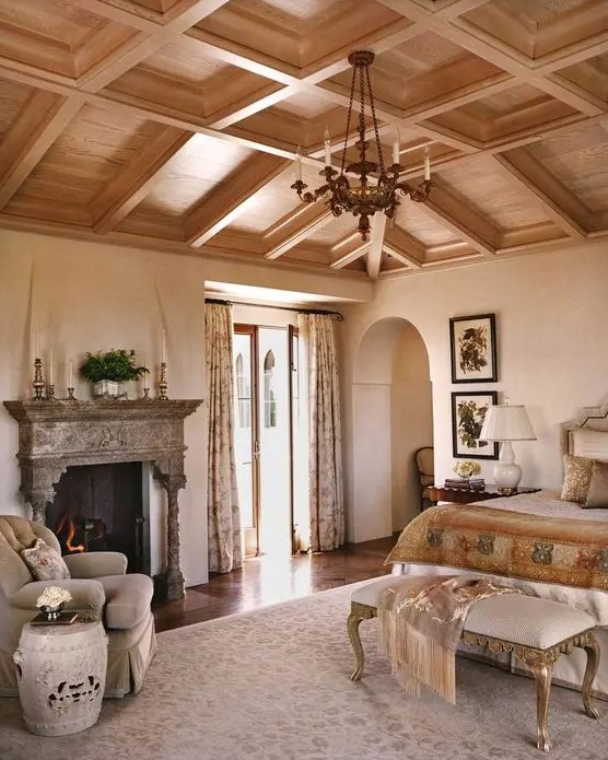 a coffered wooden ceiling makes this refined bedroom complete and brings warmth to the space