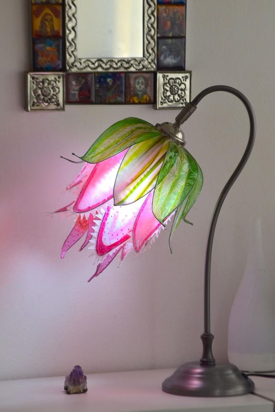 a colorful table lamp that shows off a predator flower in hot pink and green is a cool and bright idea