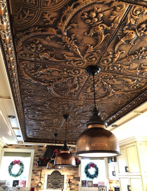 a pressed tin metal ceiling shows off a beautiful vintage pattern that adds an exquisite touch to the space