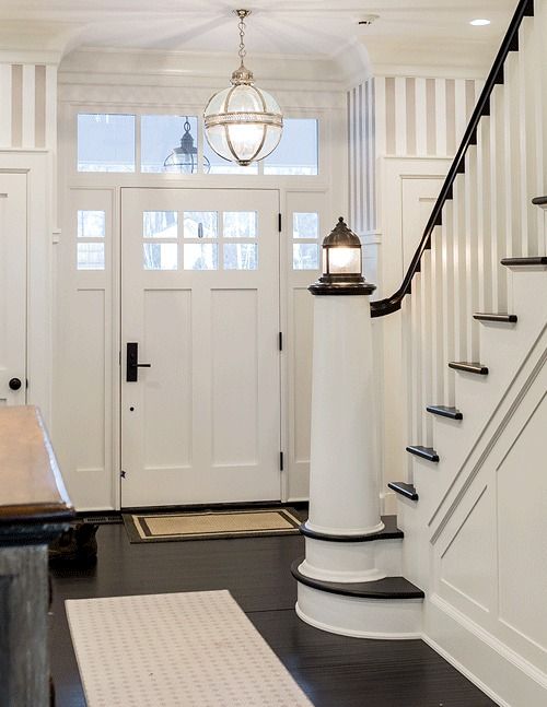 a seaside staircase in black and white, with black railing and a beacon-liek lamp on the post is a cool and bold idea