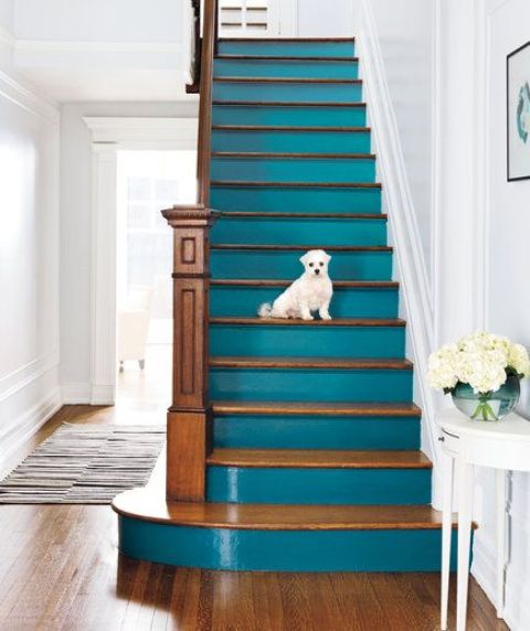 a statement coastal staircase with stained steps and teal risers is a lovely idea for a vintage coastal home