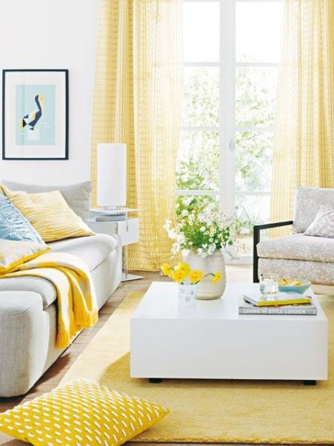 A vivacious living room with yellow curtains, a rug and some pillows feels sun filled and very bright